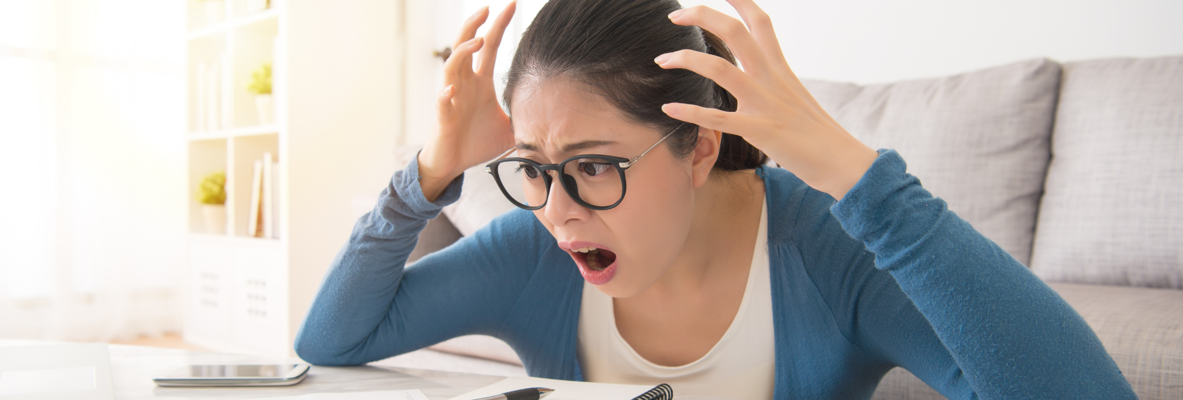 Lady looking at computer screen in shock