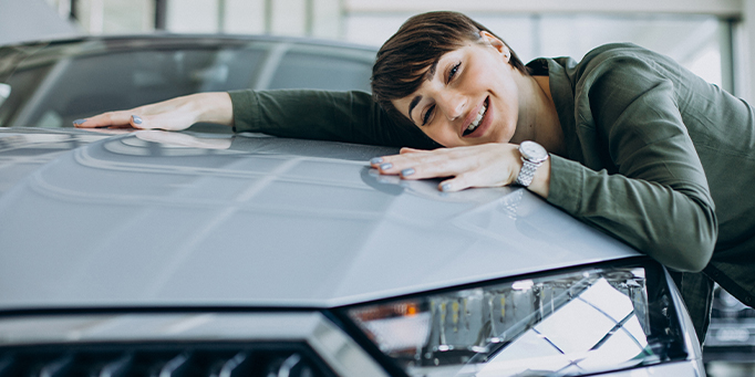 Girl hugging her first car