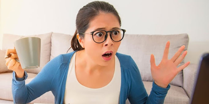 Woman worried looking at a computer