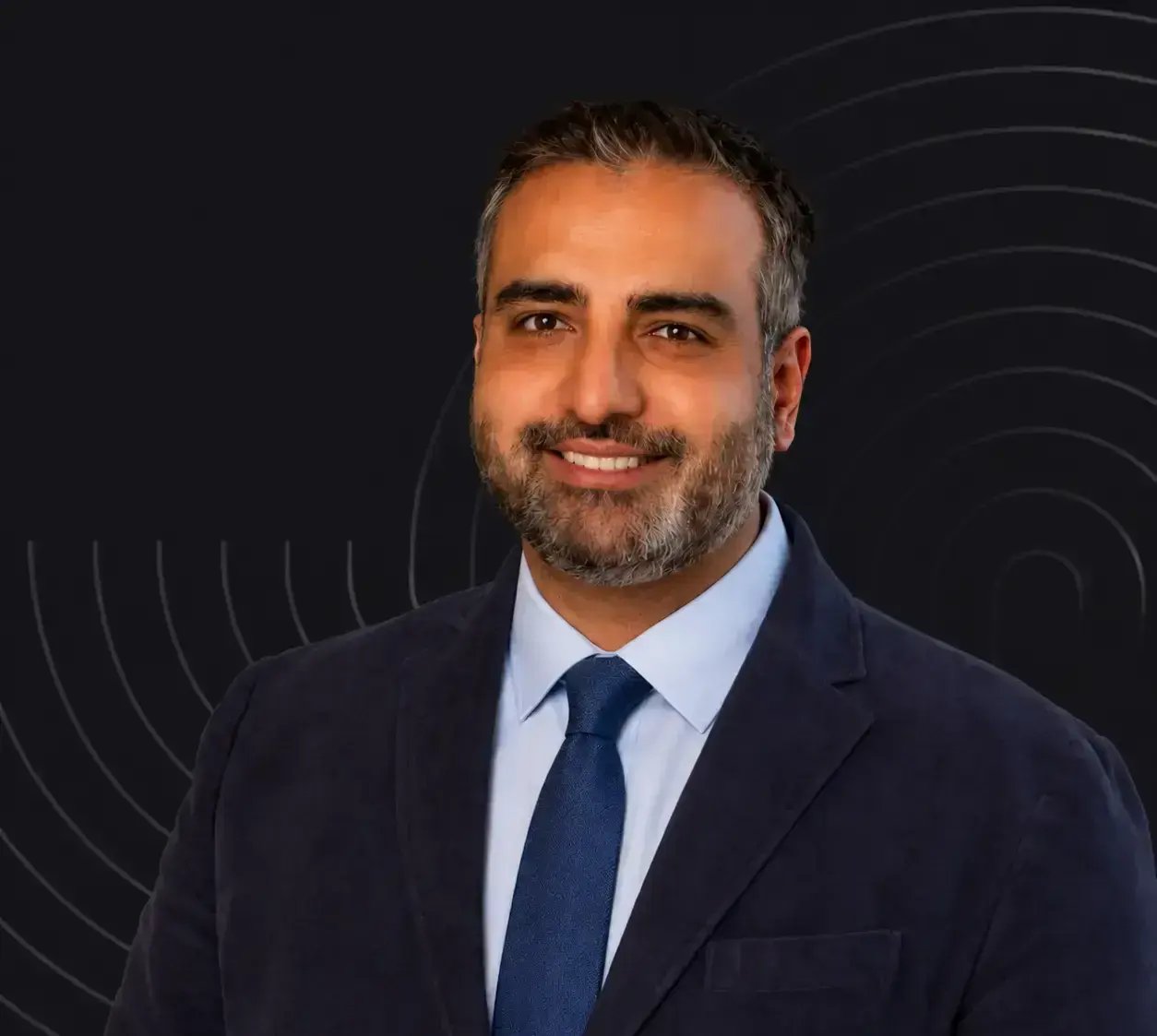 Ajay Vishisht headshot on black background with wavy lines
