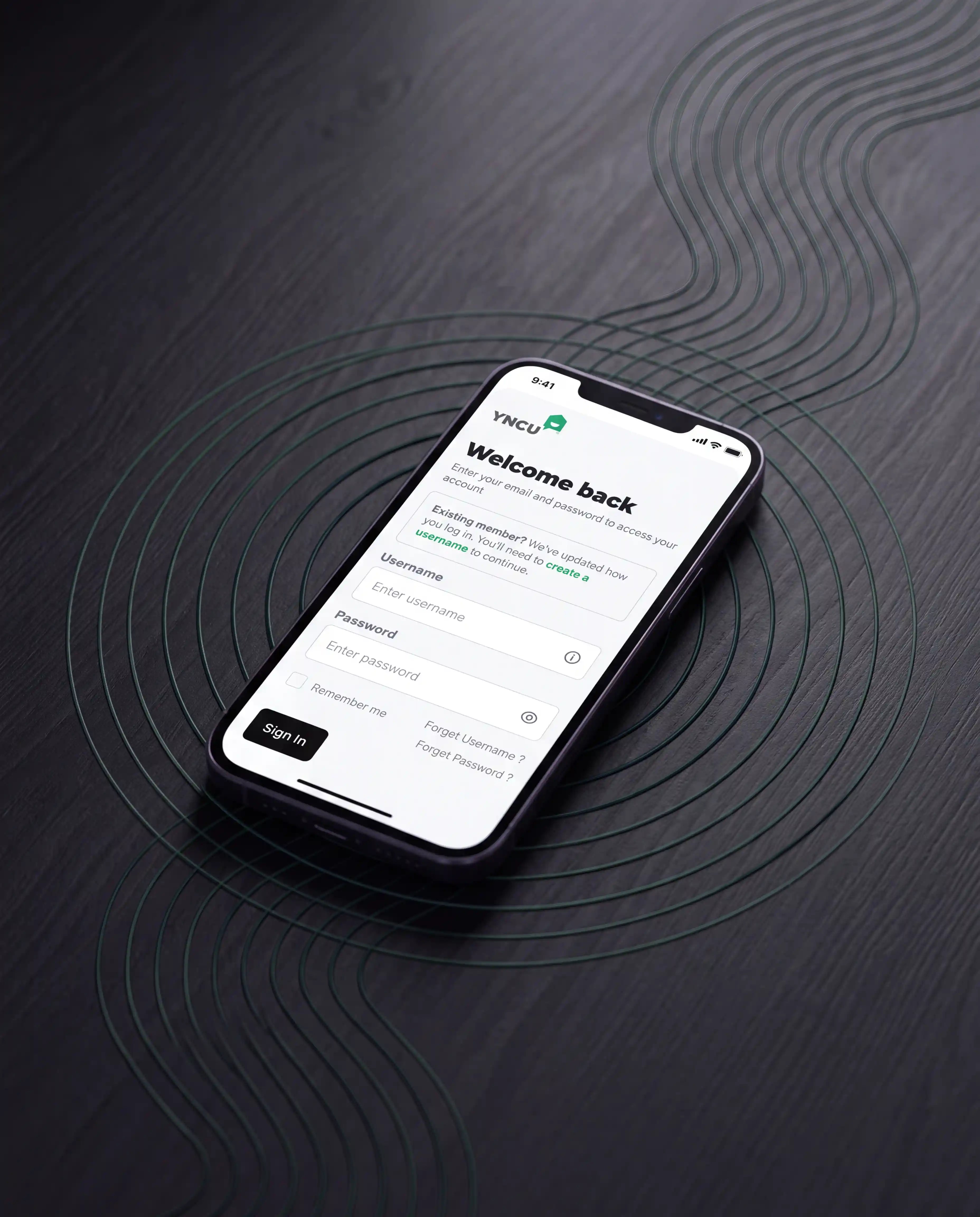 Smart phone with screen to YNCU online banking on black background with geometric designs