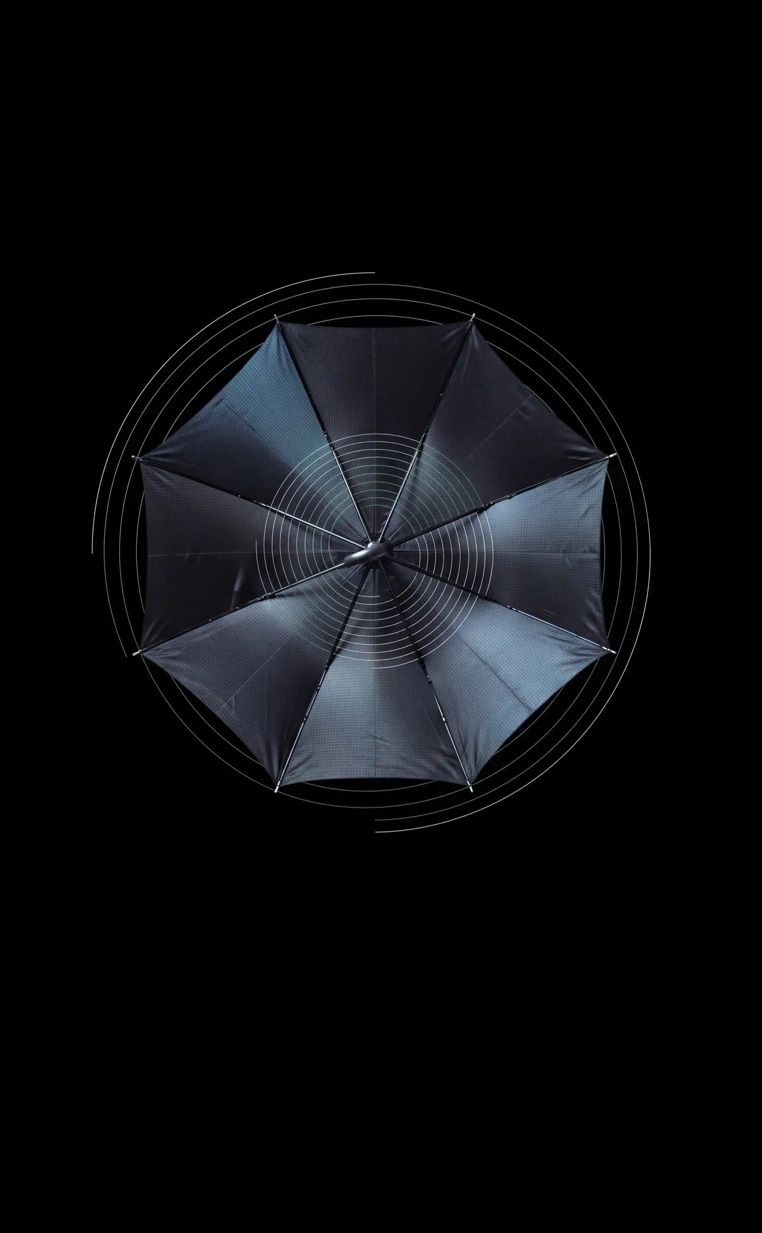 Top down view of a dark blue umbrella on a black background with geometric designs