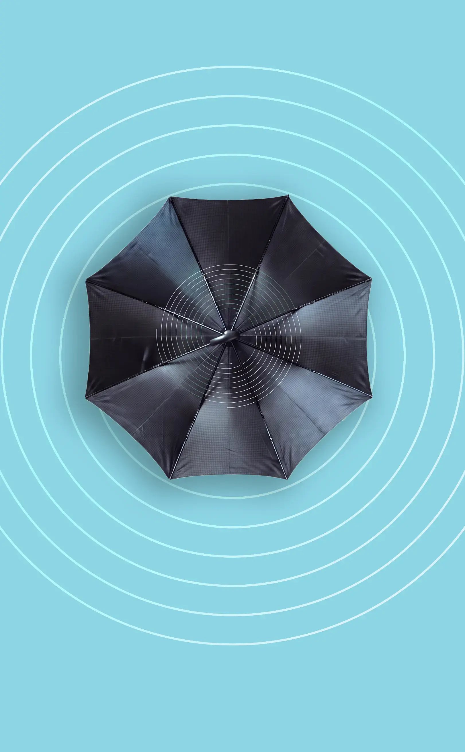 View of the top of an umbrella on a blue background with circular designs