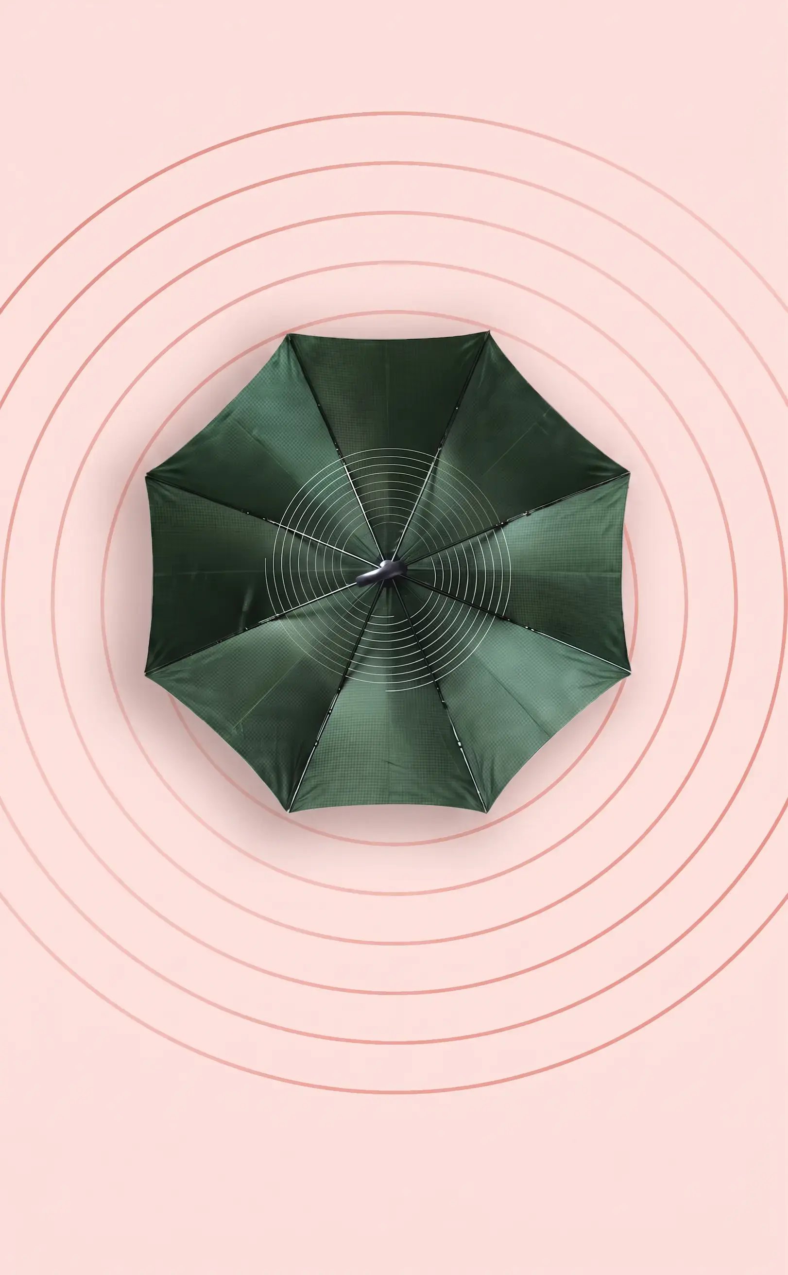 View of the top of an umbrella on a pink background with circular designs