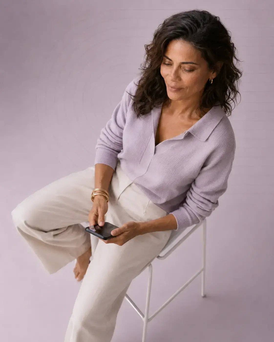 Woman-sitting-on-smartphone