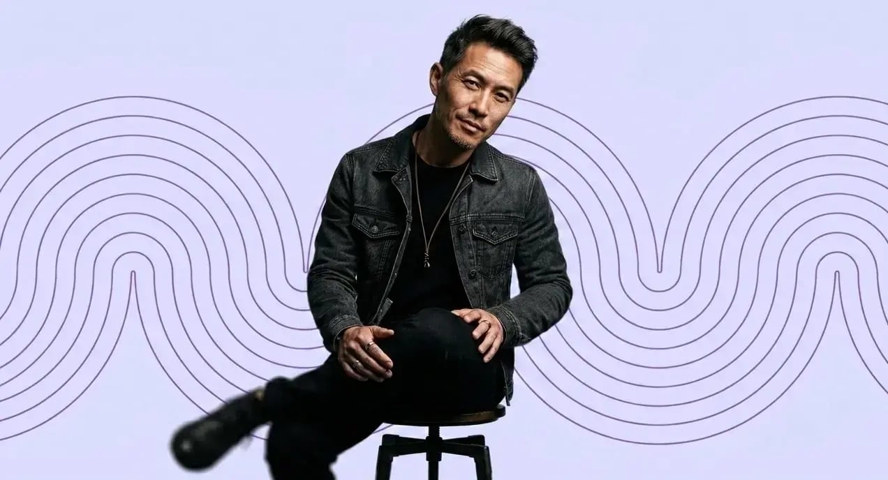 Asian-man-in-black-demim-on-a-stool
