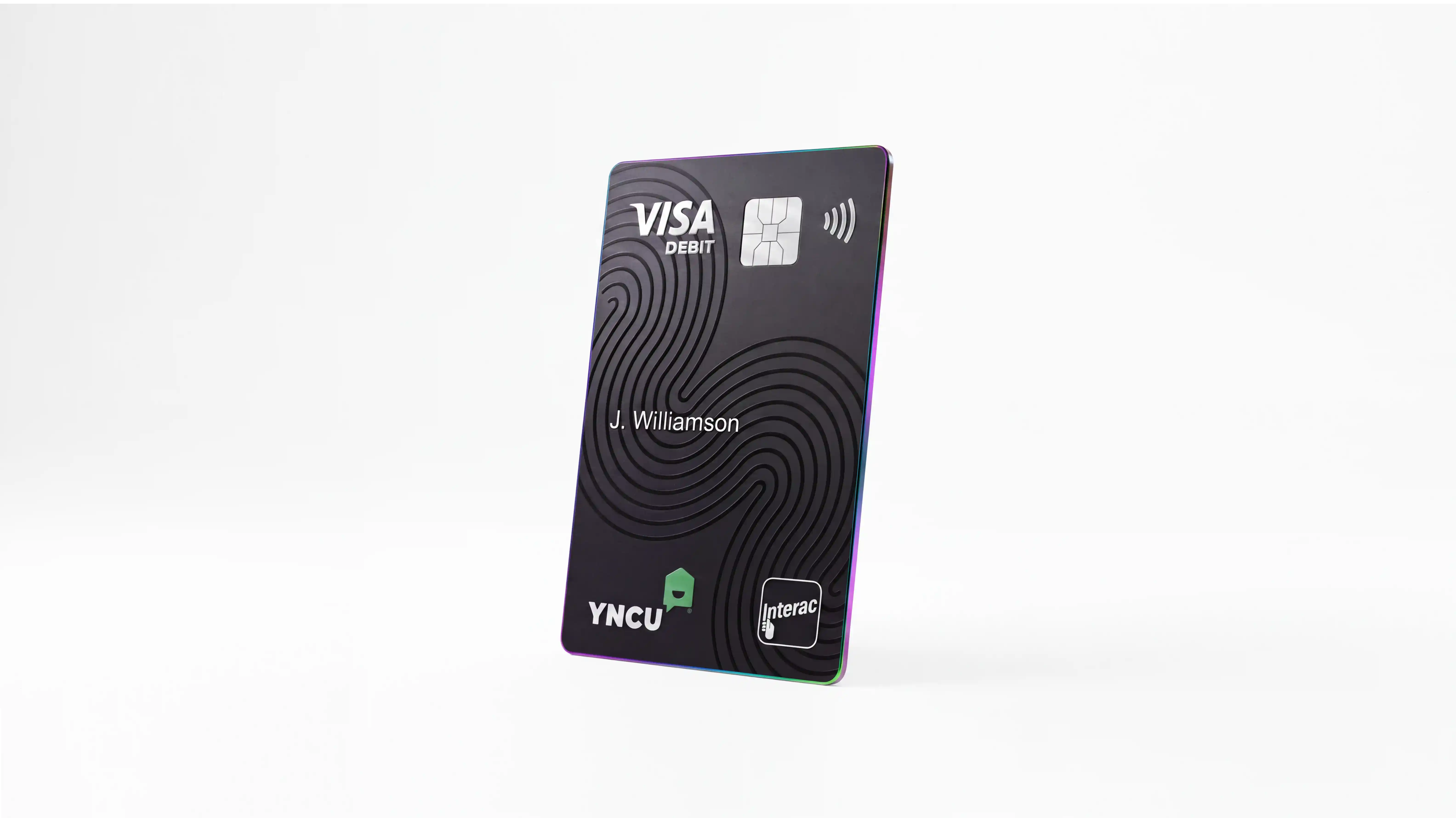 Angled view of a black YNCU Visa Debit card with Intrerac logo and chip for tap to pay on a white background